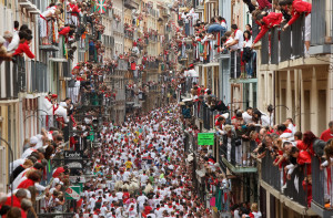 PAMPLONA, SPAIN - JULY 07: Revellers run with Torrestrella's fighting bulls along the Calle Estafeta during the second day of the San Fermin Running Of The Bulls festival on July 7, 2014 in Pamplona, Spain. The annual Fiesta de San Fermin, made famous by the 1926 novel of US writer Ernest Hemmingway 'The Sun Also Rises', involves the running of the bulls through the historic heart of Pamplona. (Photo by Pablo Blazquez Dominguez/Getty Images)